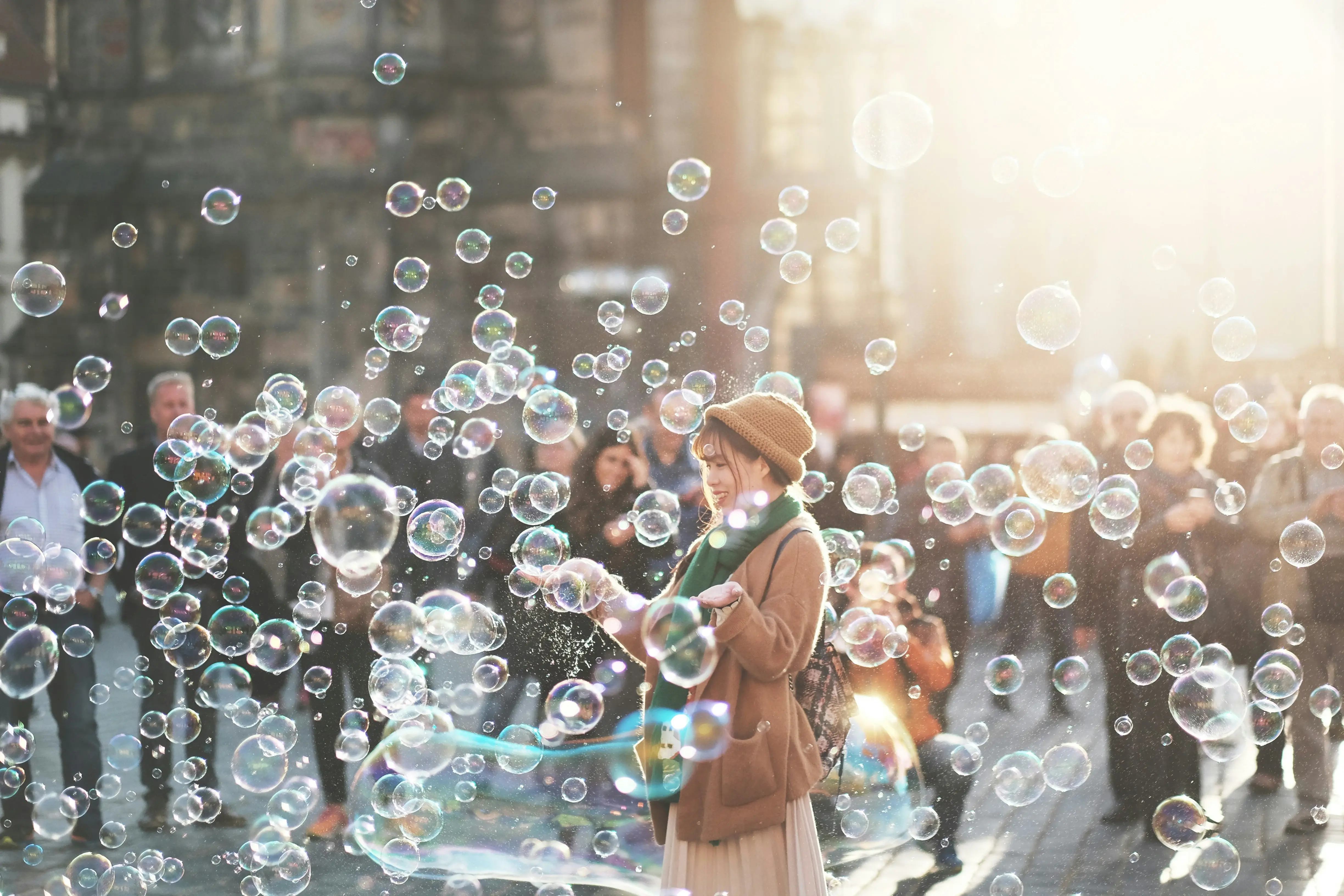 Woman smiling while surrounded by bubbles.